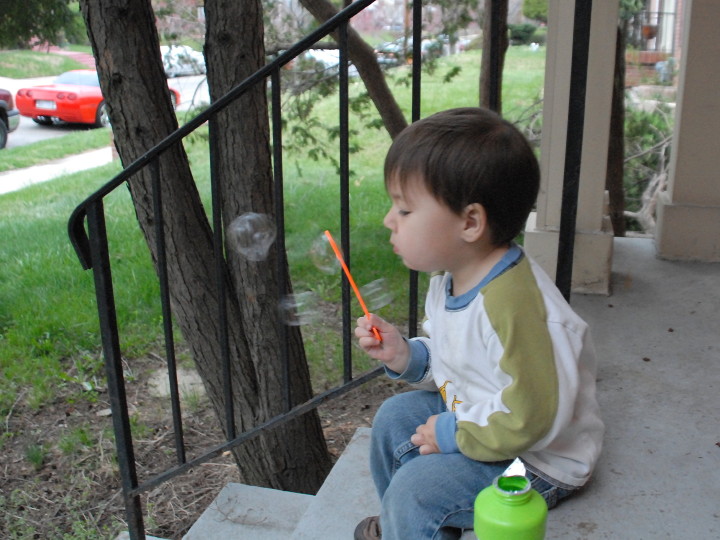 blowing bubbles on the porch