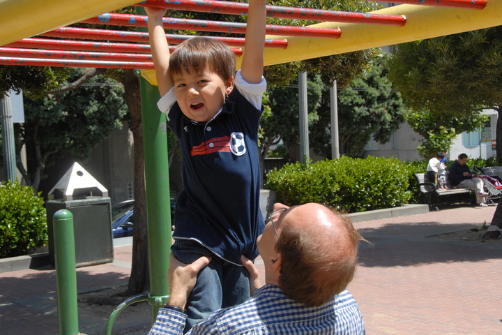 daddy helps with monkey bars