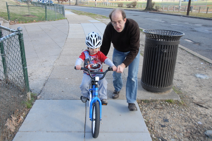 daddy helps with the bicycle